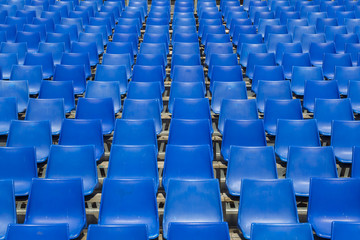 empty blue chair rows in a tribune