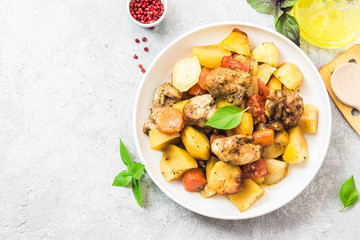 Roasted potato and carrot with lemon, garlic, spicy dressing. Top view, space for text.