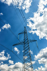 Obraz premium Power pylons and high-voltage lines against the background of the cloudy sky, power lines.