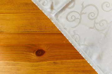 White table cloth lying on wooden table