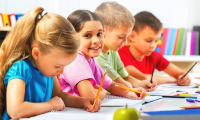 Fototapeta premium School Children in the Classroom Writing / Drawing