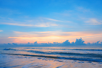 Fototapeta na wymiar Bright sunrise or sunset over the beach an impressive