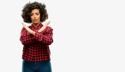 Beautiful arab woman annoyed with bad attitude making stop sign crossing hands, saying no,...