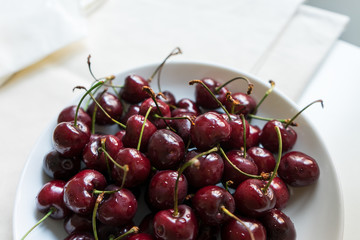 Cherries in a white bowl on a white background