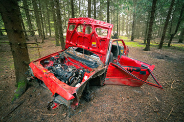 Red Wrecked car deep in the woods