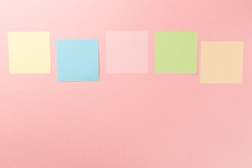 Colorful paper stickers on pink background. Top view. Flat lay. Copy space. Concept. Mock-up lot of color empty office stickers on a pink background