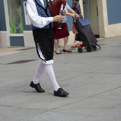 Man playing bagpipe, spanish traditional dance group