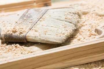 Wooden board and brush for cleaning wood chips
