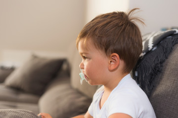 Portrait of a small cute kid with pacifier