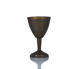 Old metal wine-glass on mirror background