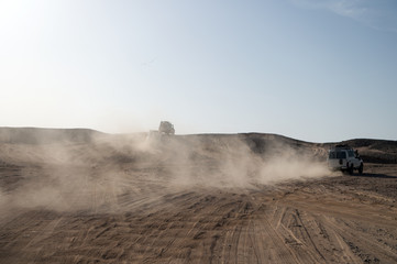 Competition racing challenge desert. Car overcome sand dunes obstacles. Car drives offroad with clouds of dust. Offroad vehicle racing obstacles in wilderness. Endless wilderness. Race in sand desert © be free