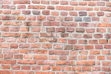 Old red brick wall in Krakow texture background. Industrial background empty grunge urban warehouse brick wall in Krakow. Old building material concept. Ancient fortification or part of defenses