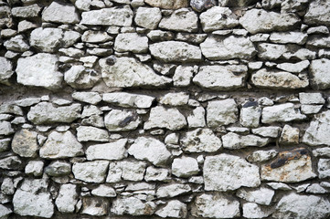 Old stony wall in Krakow texture background. Ancient background empty wall made out of stones in Krakow. Old building material concept. Ancient stony fortification or part of defenses