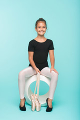 Child flexible gymnast practice stretching tiptoes. Child tender dancer look gorgeous fancy leotard. Dream every girl become famous gymnast. Kid sit hold pointe ballet shoes. Special shoes for ballet