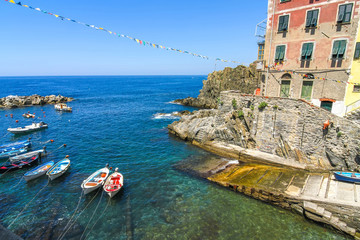 View on the beautiful colourful houses and the floating fishing boats in the harbour of Cinque Terre, Italy. © Spectral-Design