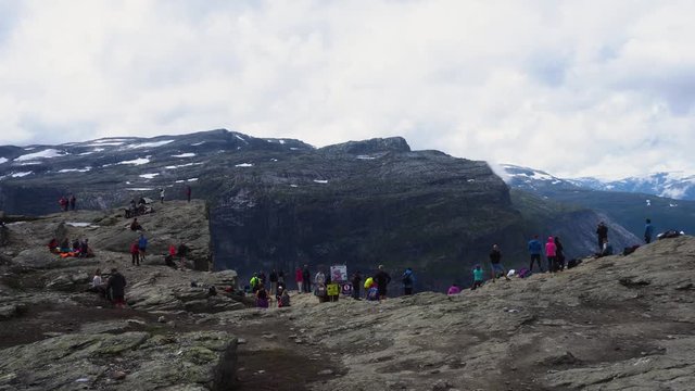Many people at the top of Trolltunga path in Norway.