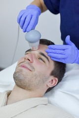 Young man on face treatment