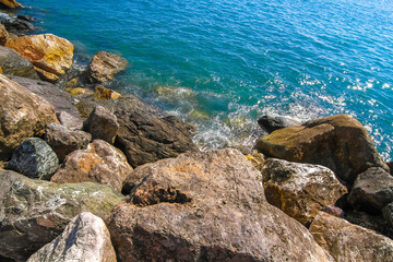 Fototapeta na wymiar Rocks in the blue Mediterranean Sea on a bright sunny day.