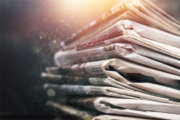 Pile of newspapers on white background