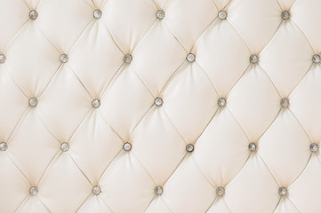 Beige soft tapestry pattern background with symmetrical buttons on the corners of diamonds. Soft...