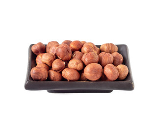 Hazelnuts in a ceramic saucer