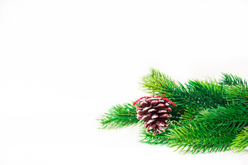 Christmas fir branches with different decoration like scarlet balls, pine cones. On white background.