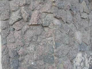 A wall lined with a coarse gray stone