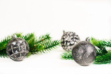 Christmas fir branches with different decoration like scarlet balls, pine cones. On white background.