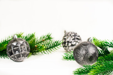 Christmas fir branches with different decoration like scarlet balls, pine cones. On white background.