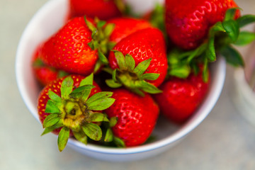 Closeup of Fresh Whole Strawberries in a White Bowl