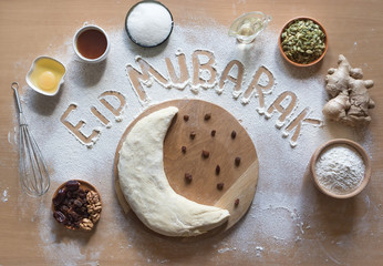 Eid Mubarak - Islamic holiday welcome phrase " happy holiday", greeting reserved. Arabic cuisine background.