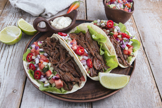Mexican tacos with roasted beef ,sauce and salsa tomato
