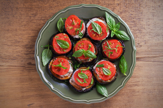 Aubergines with tomatoes and sauce. Pan fried eggplants. Healthy vegetarian food, appetizer. overhead, horizontal