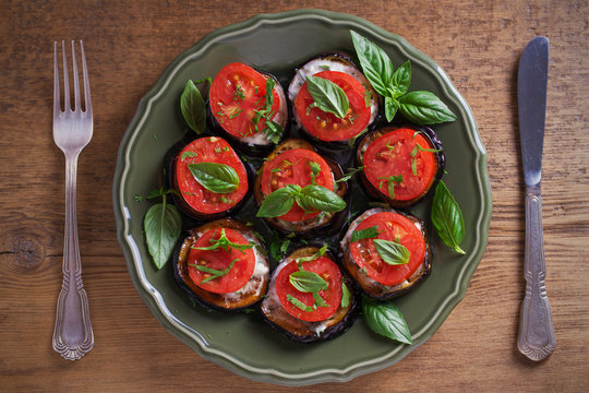 Aubergines with tomatoes and sauce. Pan fried eggplants. Healthy vegetarian food, appetizer. overhead, horizontal