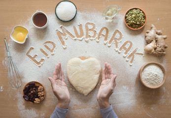 Eid Mubarak - Islamic holiday welcome phrase " happy holiday", greeting reserved. Arabic cuisine background.
