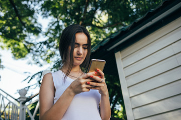 Portrait of happy young woman using smart phone