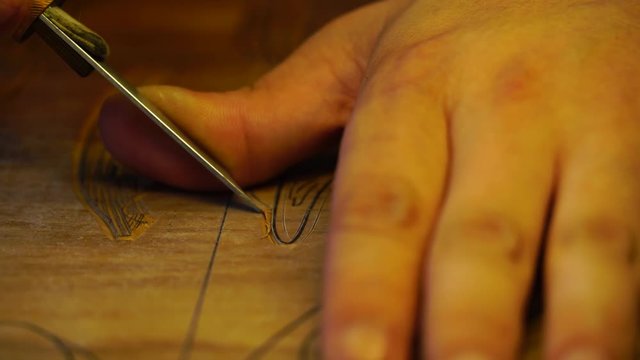 Closeup Of Hands Doing Chinese Wood Block Art Carving. Asian Artisan Preparing Woodblock For Printing Patterns On Rice Paper. Tang Dynasty Technique Of Print Cutting, Ancient Art In China.