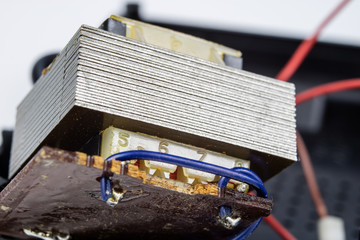 Old integrated circuits in an analog radio receiver. Resistors, transistors and other circuits on an old integrated circuit board.