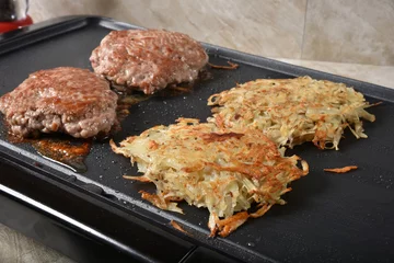Acrylic prints Cooking Sausage and hash browns cooking