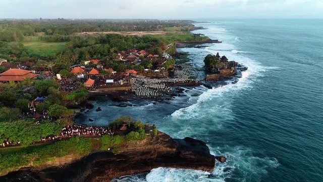 Amazing aerial view of dancing with the participation of 1800 balinese dancers in Tanah Lot Temple, Bali, Indonesia.