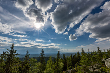Beautiful landscape with forest, clouds and sun in Koli National Park, Finland