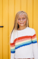 Portrait of beautiful Little girl with yellow background