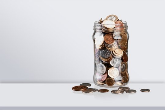 Money Jar with  coins on background