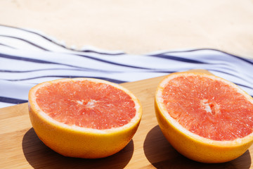 Fototapeta na wymiar Cut grapefruit on cutting board