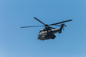 Fototapeta na wymiar Helicopter Military Flying Blue Sky