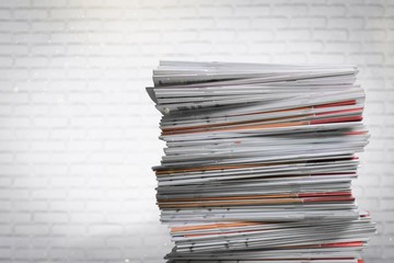Stack of business documents on brick background