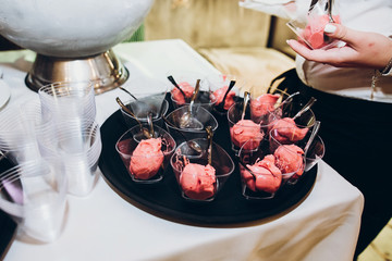 strawberry organic ice cream in glasses. master class of making natural fruit ice cream. confectioner making homemade ice cream at wedding reception in restaurant.