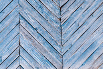 Aged painted cracked boards with blue color peeling. Old natural grunge textured wooden background. Weathered wood wall for design