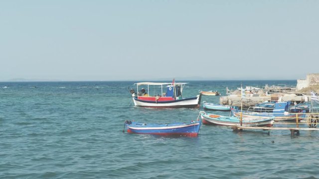 Small local fishing port in Greek village bird flying over