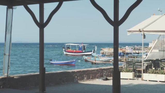 Wide shot of small local fishing port in Greek village